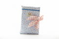 Handmade quilted book sleeve featuring a pink peony and blue vine print cotton fabric, accented with a large hand-tied coral gingham bow on the side.