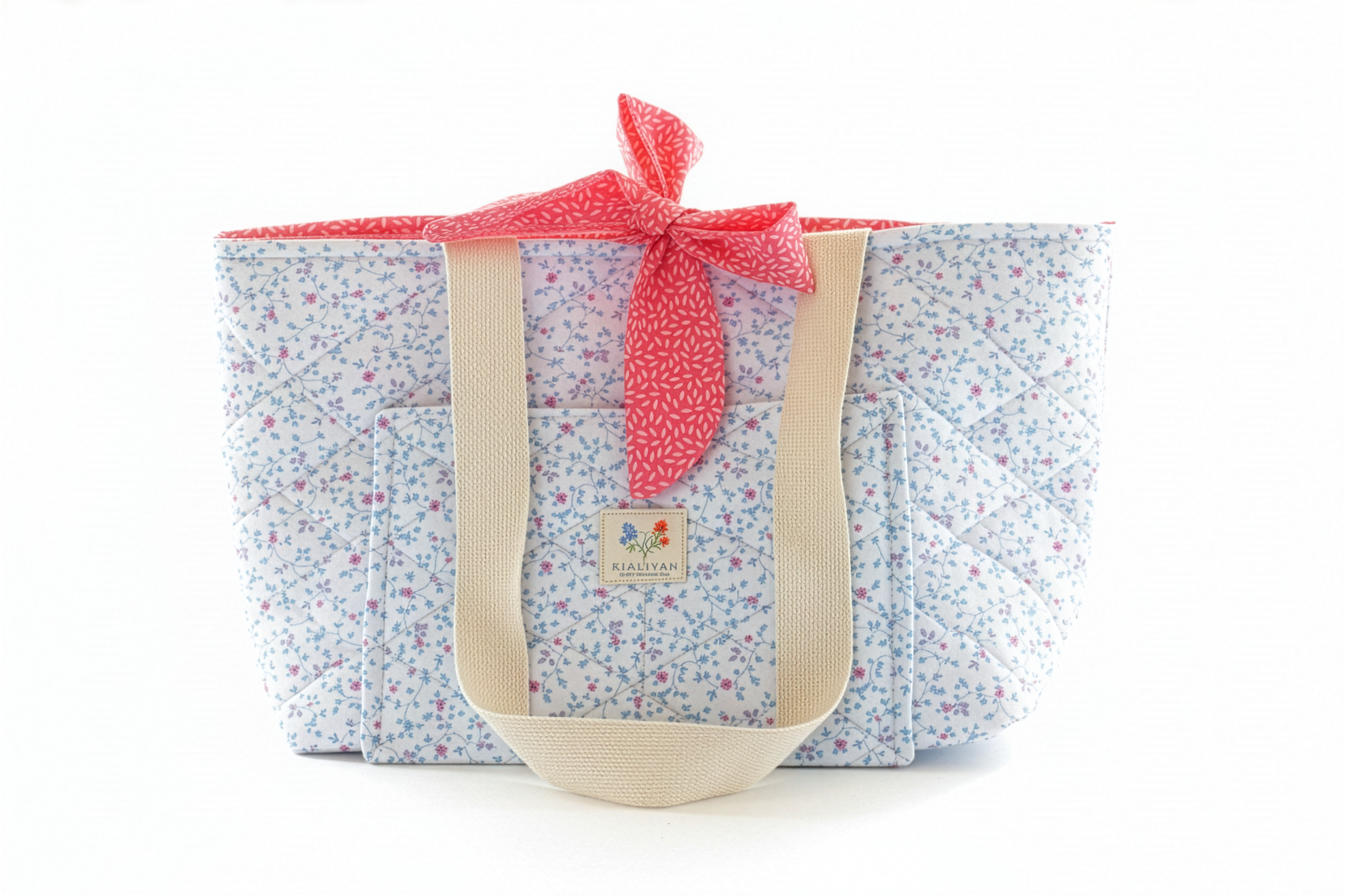 Floral-patterned tote bag with a red ribbon on a white background