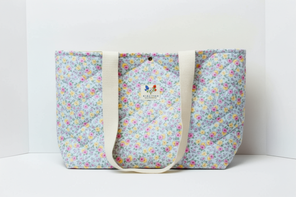 Floral patterned tote bag with visible brand logo on a white background