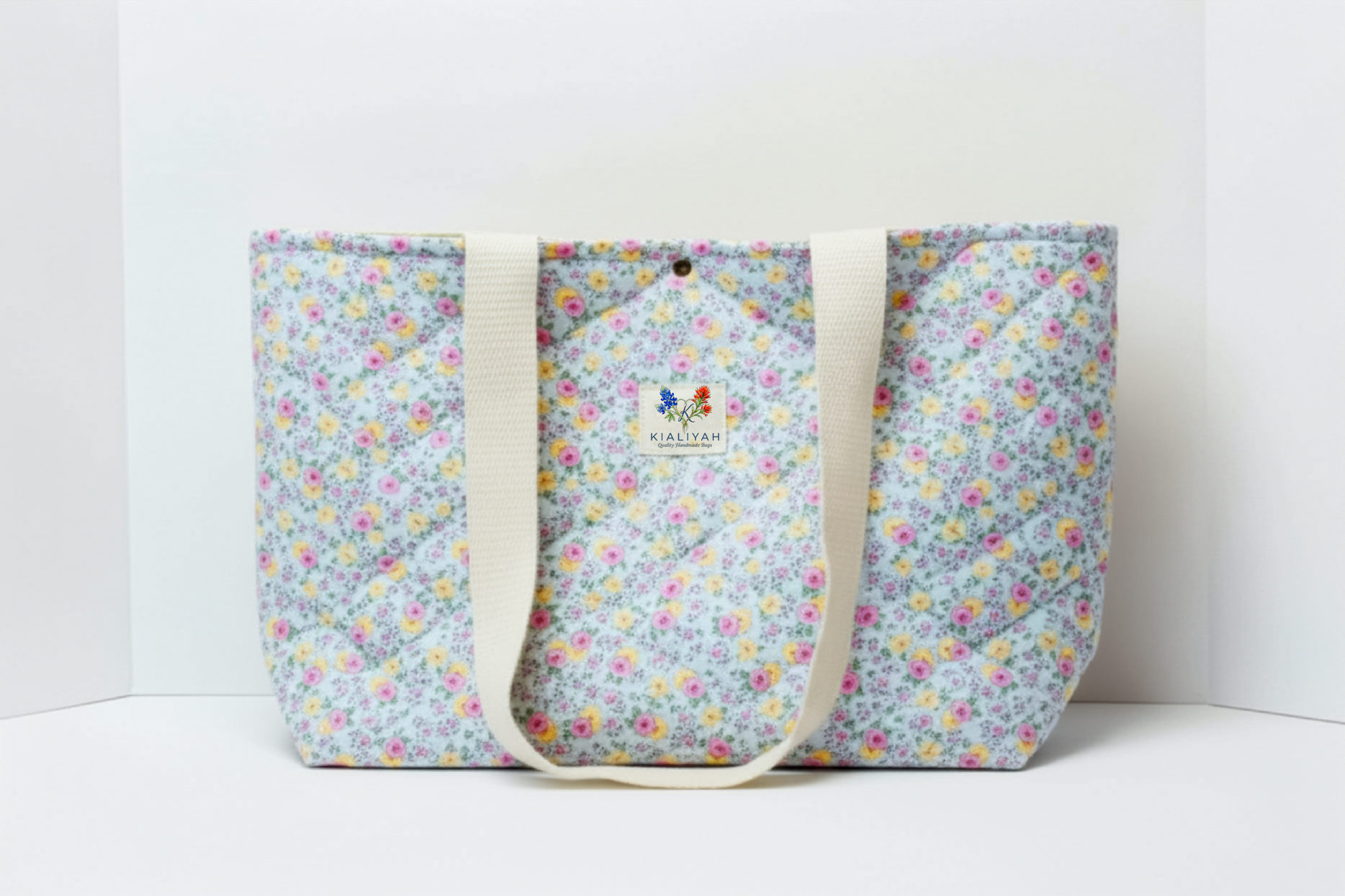 Floral patterned tote bag with visible brand logo on a white background