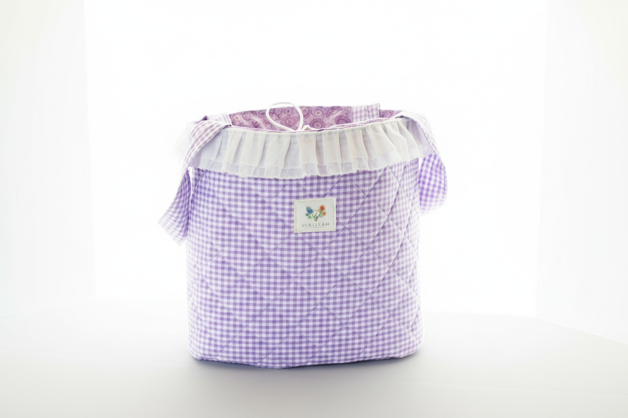 Purple checkered laundry basket with a white label on a light gray background