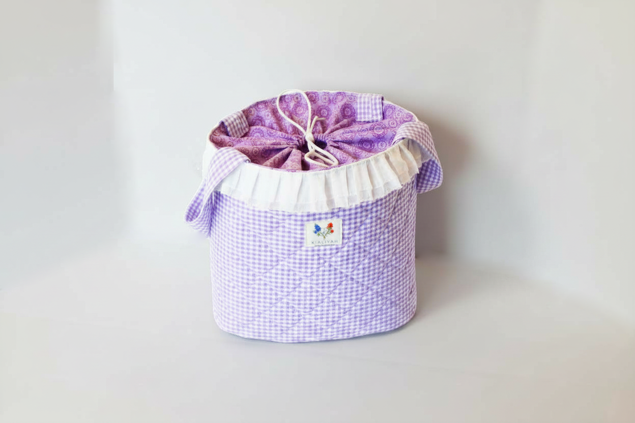 Purple checkered drawstring bag on a light gray background