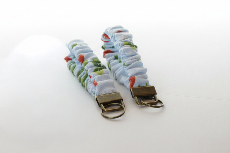 Two fabric keychains with floral patterns on a white background