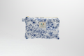 The Blue Toile Quilted Coin Pouch & Small Wallet featuring a monochrome blue pastoral toile print on cotton fabric, designed with vertical channel quilting, a gold-tone top zipper with a matching fabric pull-tab, and a centered white KIALIYAH label.