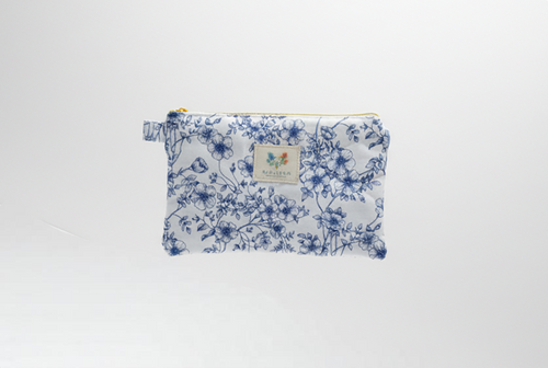 The Blue Toile Quilted Coin Pouch & Small Wallet featuring a monochrome blue pastoral toile print on cotton fabric, designed with vertical channel quilting, a gold-tone top zipper with a matching fabric pull-tab, and a centered white KIALIYAH label.