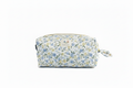 The Meadow Flora Quilted Cosmetic Pouch featuring a delicate blue and yellow botanical print on cream fabric, designed with vertical channel quilting, a flat stand-up base, a gold-tone zipper with a matching fabric pull-tab, and a centered white KIALIYAH label.